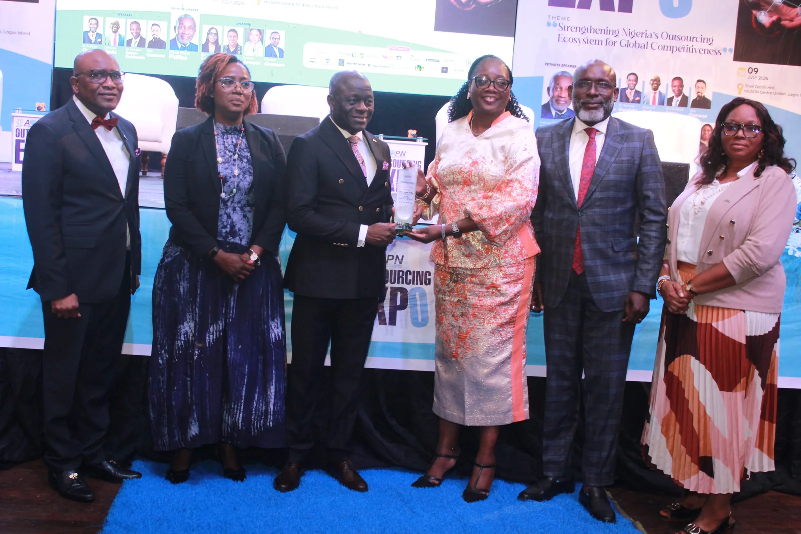 Award recipient and event leaders at Outsourcing Expo 2026